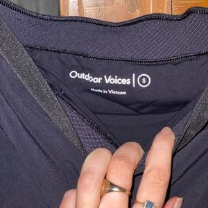Outdoor Voices dark navy running shorts with black waistband